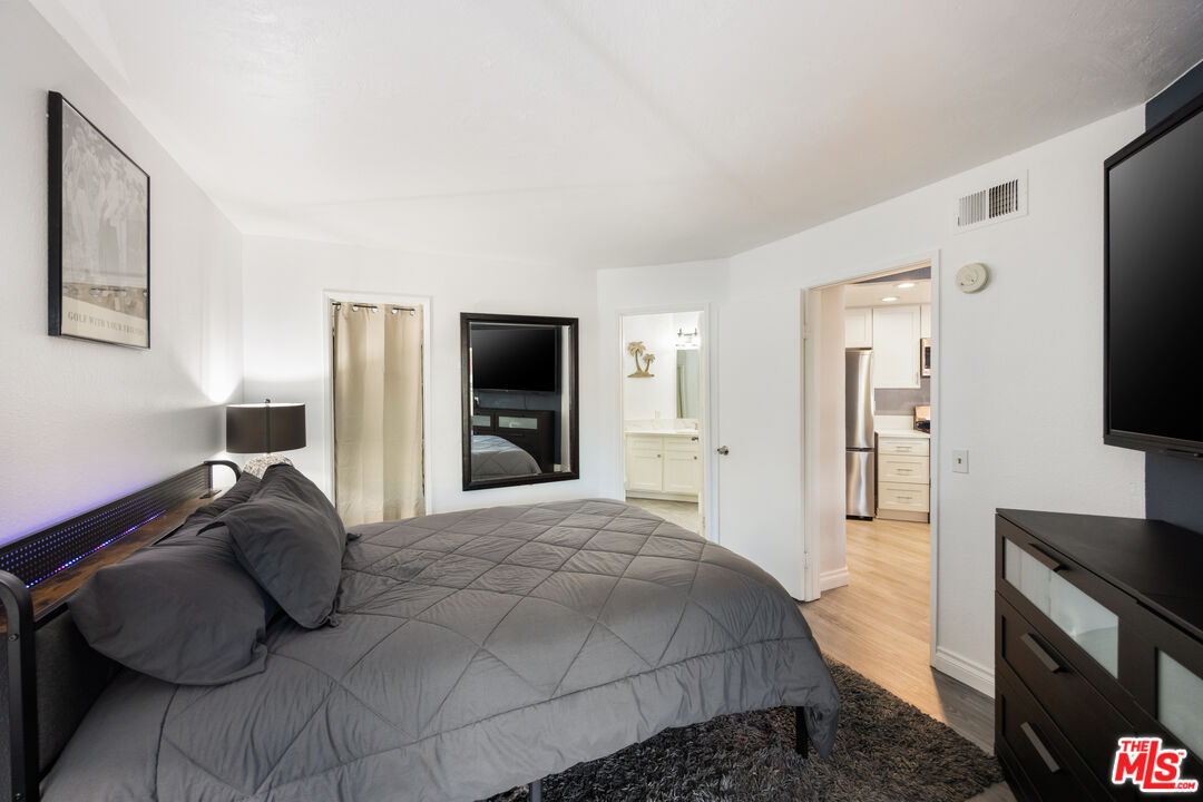 2963 Alwood Court Spring Valley, CA 91978 - Photo 11 of 20 a bedroom with a bed and a flat screen tv