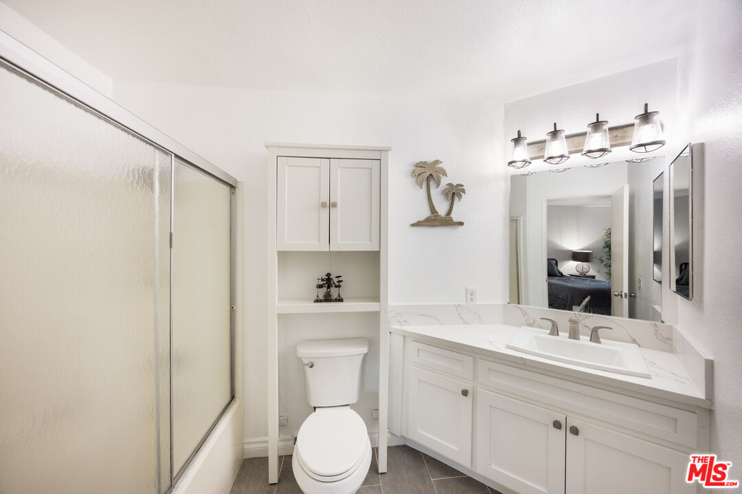 2963 Alwood Court Spring Valley, CA 91978 - Photo 12 of 20 a bathroom with a toilet sink a mirror and vanity