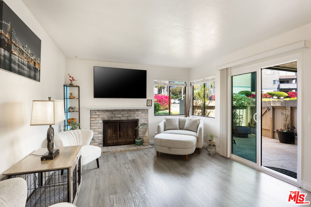 2963 Alwood Court Spring Valley, CA 91978 - Photo 2 of 20 a living room with furniture a fireplace and a flat screen tv