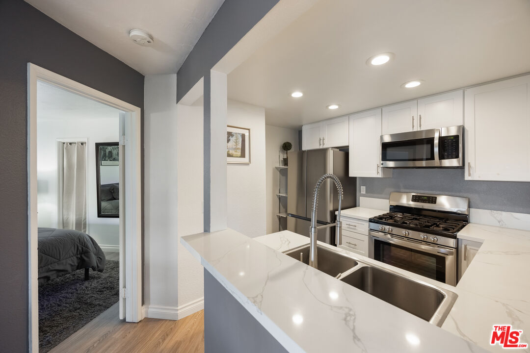 2963 Alwood Court Spring Valley, CA 91978 - Photo 5 of 20 a kitchen with granite countertop a sink stainless steel appliances and cabinets