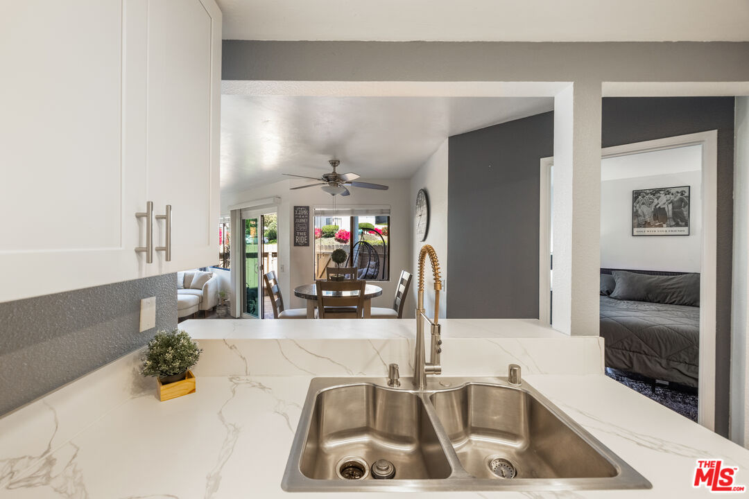 2963 Alwood Court Spring Valley, CA 91978 - Photo 7 of 20 a kitchen with sink refrigerator and window