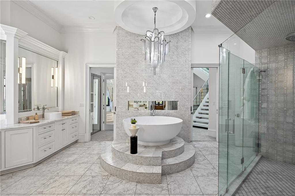 5320 Riverview Road Northwest Atlanta, GA 30339 - Photo 22 of 83 a spacious bathroom with a double vanity sink a toilet a mirror and shower