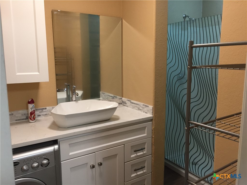 4841 Highway 35, Unit 203 Rockport, TX 78382 - Photo 12 of 23 a bathroom with a sink and a mirror