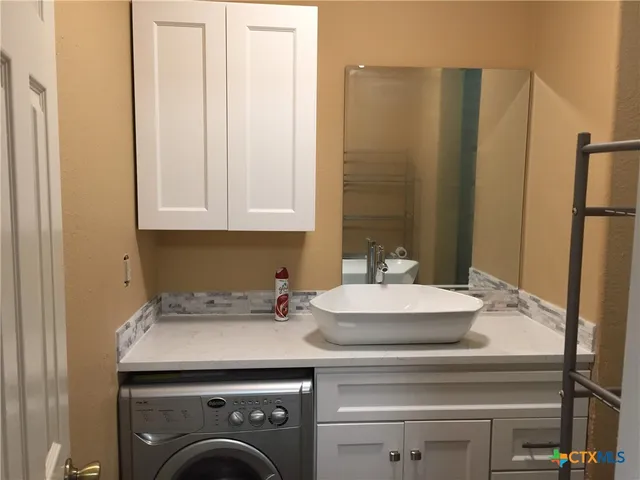 a kitchen with a sink and cabinets