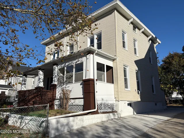 a view of dirt road with a building in the background