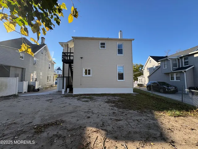 a kitchen with stainless steel appliances granite countertop a stove top oven a sink and white cabinets