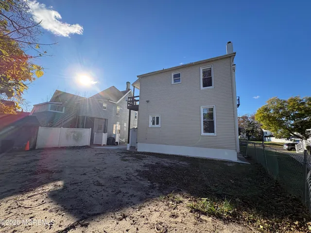 a kitchen with granite countertop white cabinets white appliances a sink and dishwasher