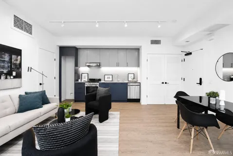 a living room with furniture and kitchen view