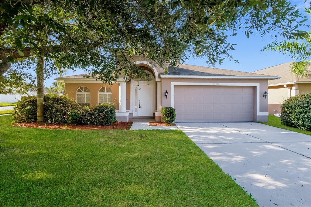 17326 Poppy Fields Lane Land O Lakes, FL 34638 - Photo 1 of 15 front view of a house with a garden