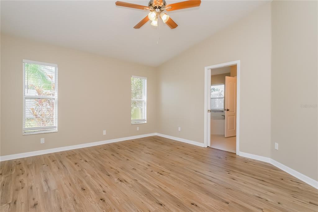 17326 Poppy Fields Lane Land O Lakes, FL 34638 - Photo 14 of 15 a view of an empty room with a window and wooden floor