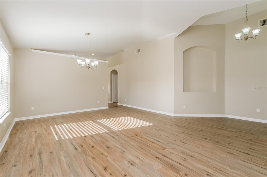 17326 Poppy Fields Lane Land O Lakes, FL 34638 - Photo 3 of 15 wooden floor in a room with a mirror