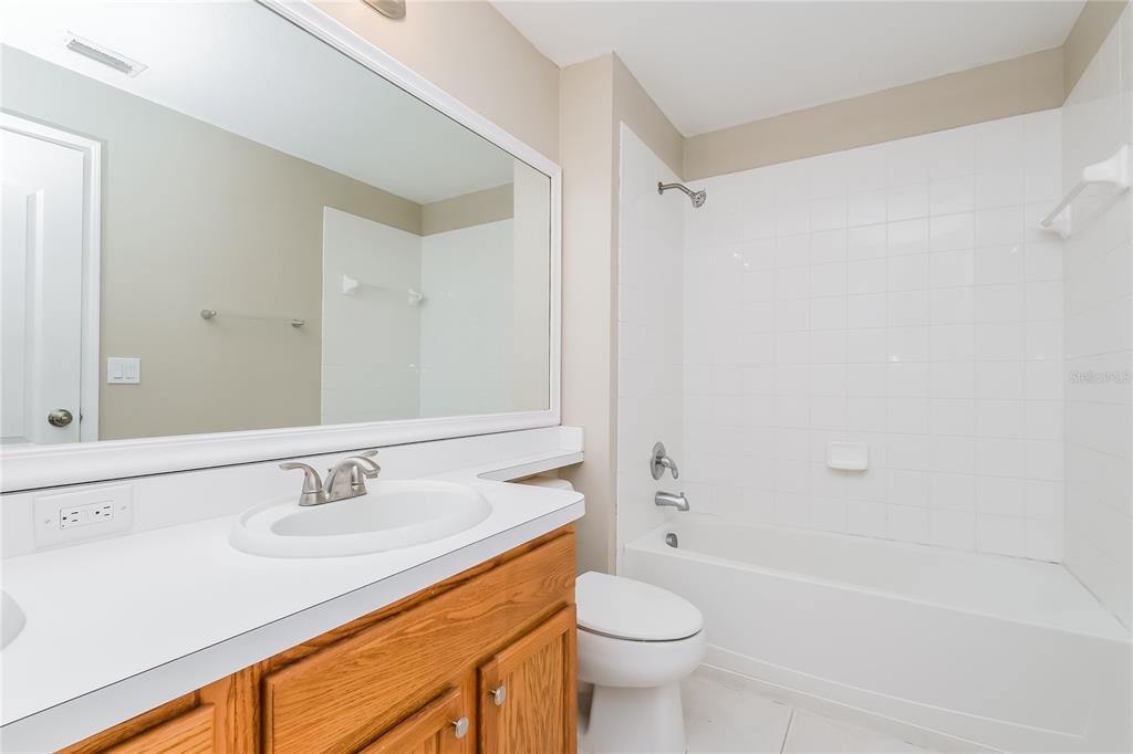 17326 Poppy Fields Lane Land O Lakes, FL 34638 - Photo 7 of 15 a bathroom with a sink a toilet and shower