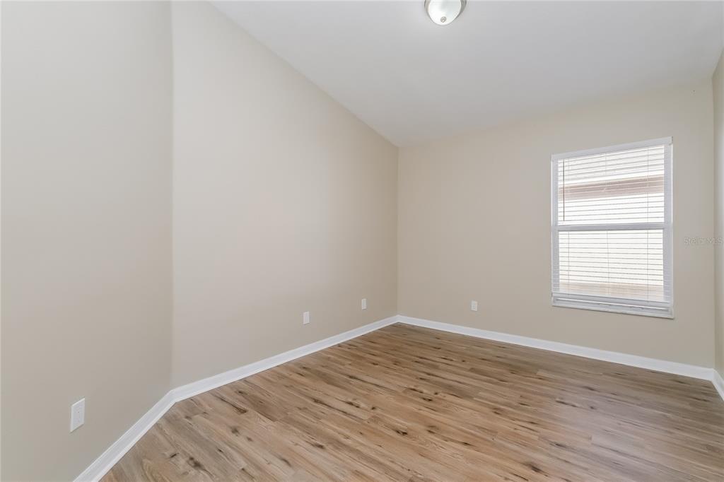 17326 Poppy Fields Lane Land O Lakes, FL 34638 - Photo 9 of 15 a view of a room that has wooden floor and a window in it