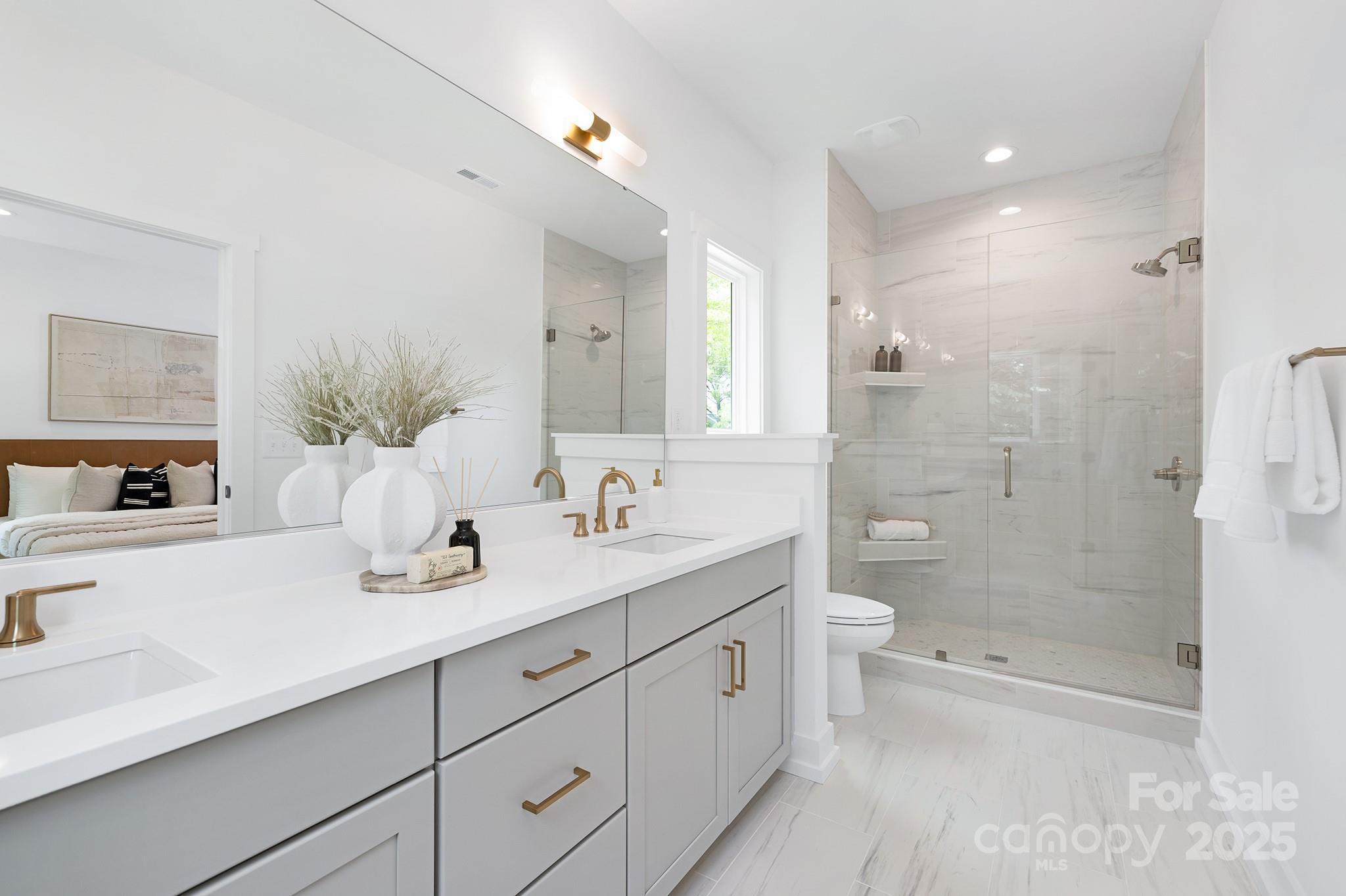 511 Bowman Road Charlotte, NC 28217 - Photo 12 of 21 a spacious bathroom with a granite countertop sink a toilet a shower and a mirror