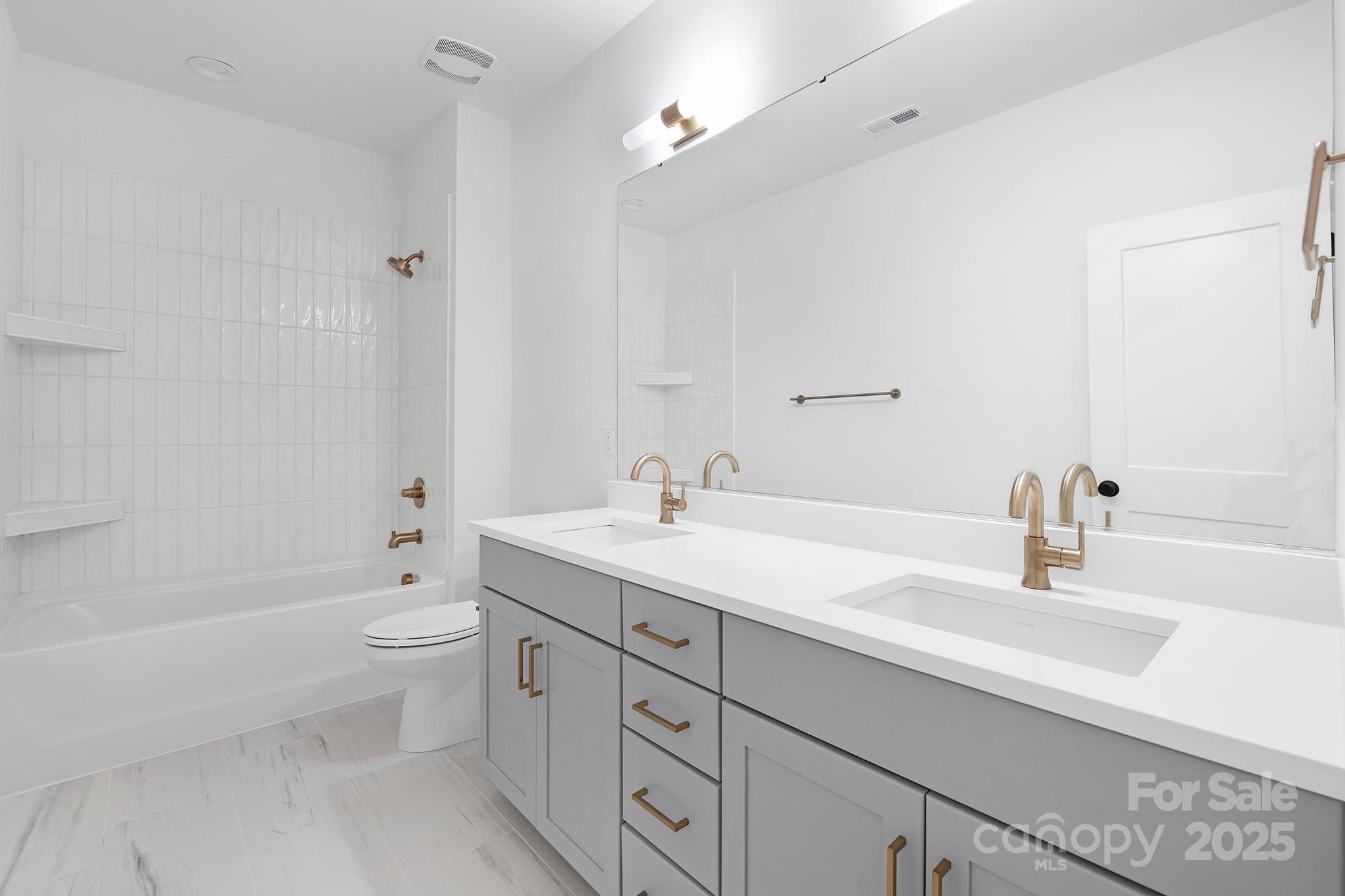 511 Bowman Road Charlotte, NC 28217 - Photo 15 of 21 a bathroom with a granite countertop sink a toilet and shower