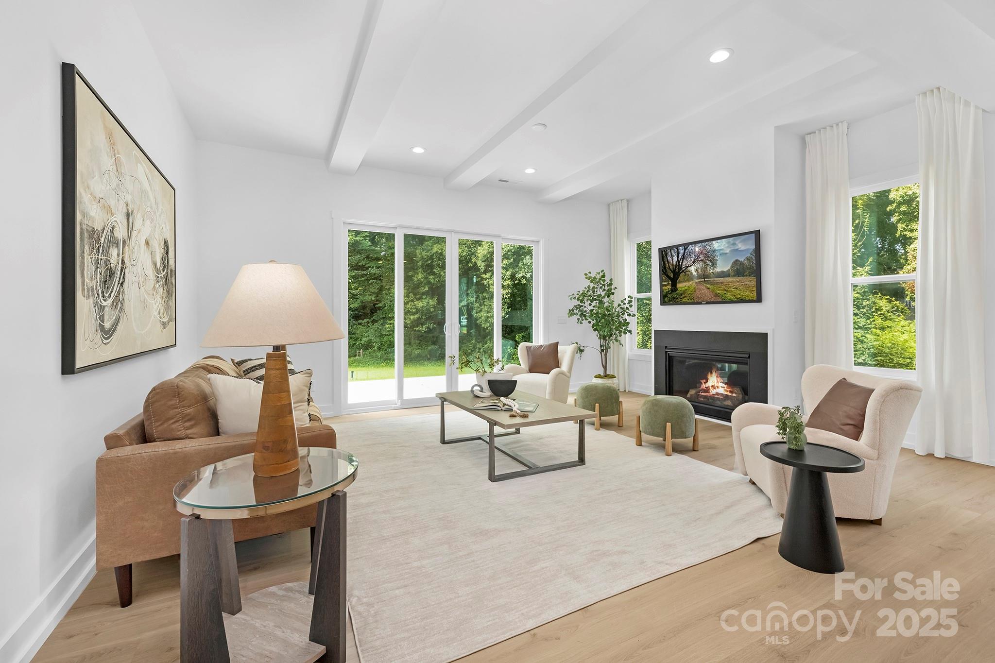 511 Bowman Road Charlotte, NC 28217 - Photo 4 of 21 a living room with furniture fireplace and large windows