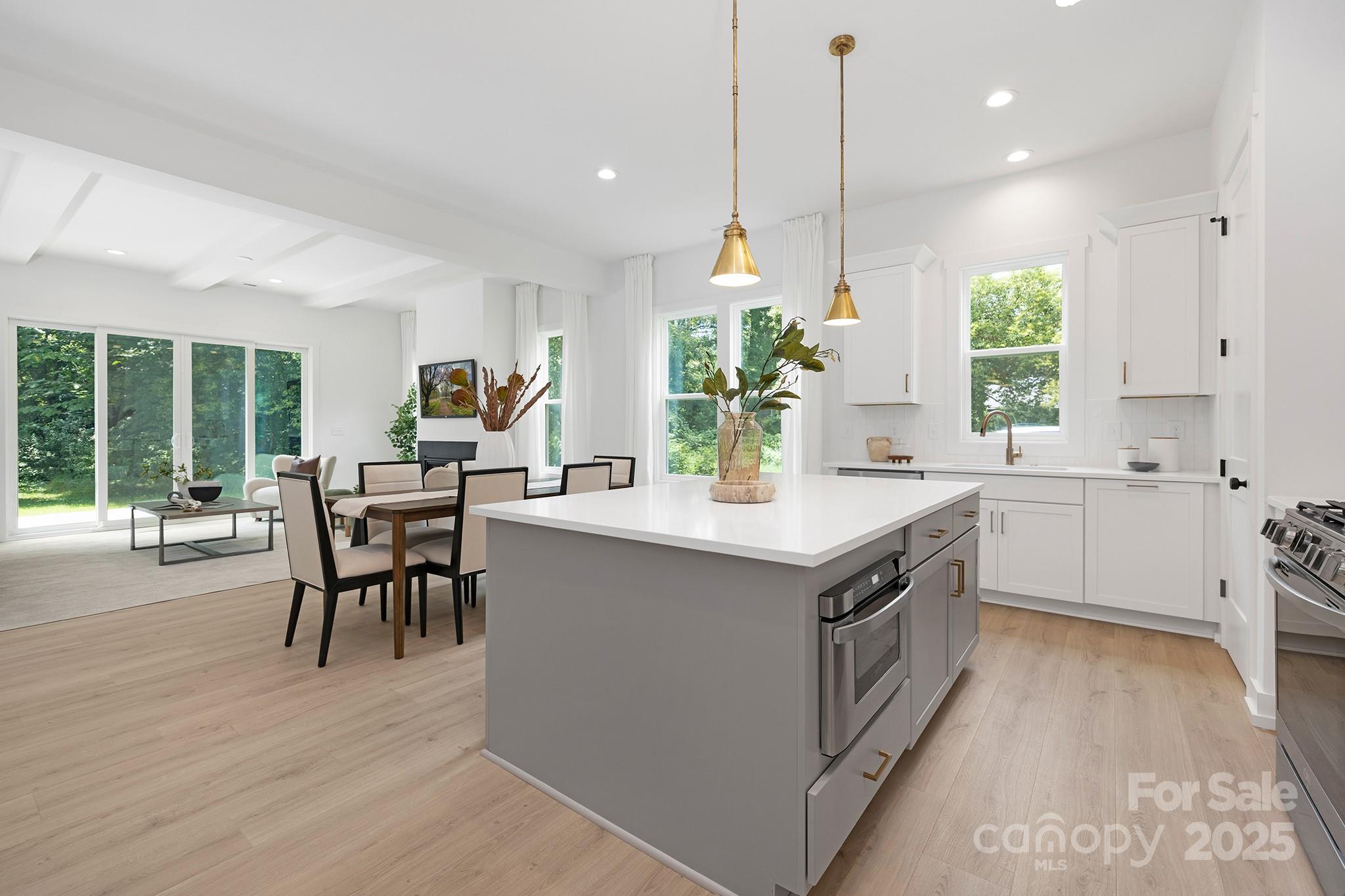 511 Bowman Road Charlotte, NC 28217 - Photo 7 of 21 a kitchen with a table chairs sink and cabinets