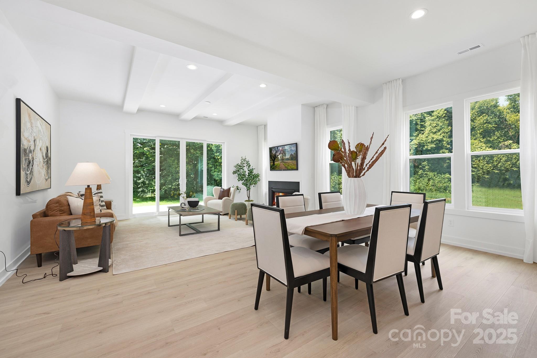 511 Bowman Road Charlotte, NC 28217 - Photo 9 of 21 a dining room with furniture large windows and a wooden floor