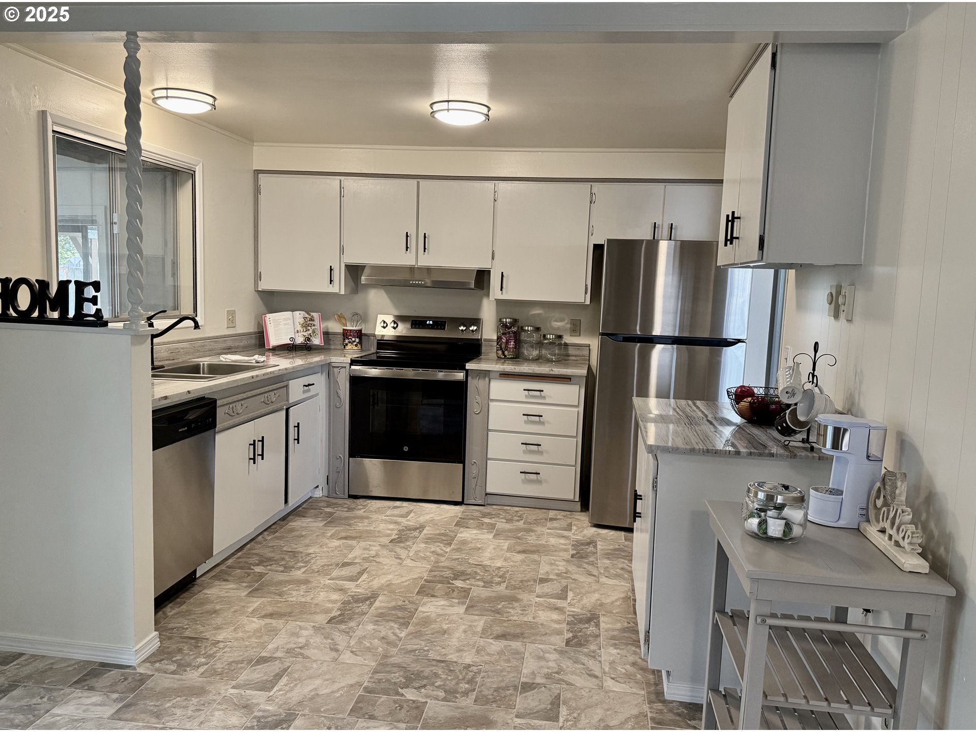 1220 Mill Street Springfield, OR 97477 - Photo 6 of 23 a kitchen with stainless steel appliances a refrigerator stove and sink