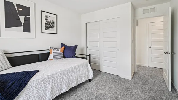 a bedroom with a bed and cabinets