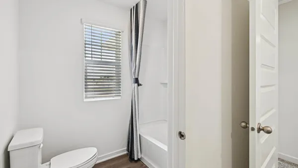 a white toilet sitting next to a bathroom sink