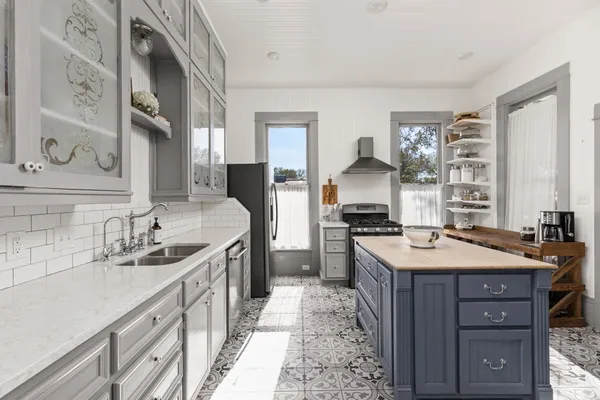 a kitchen with a sink stove and cabinets