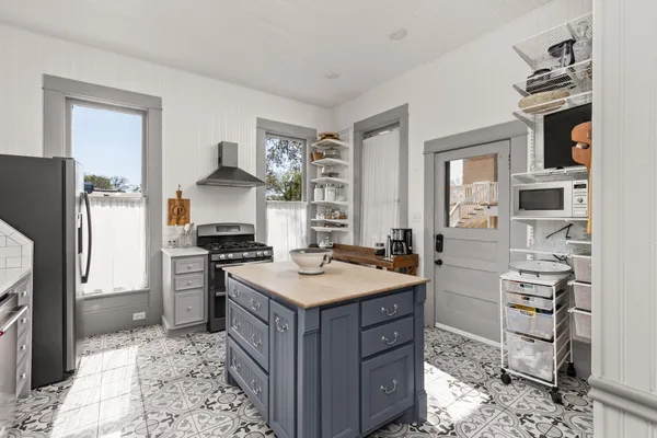 a kitchen with cabinets and refrigerator