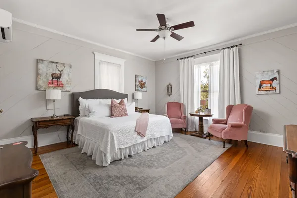 a bedroom with a bed and a chair