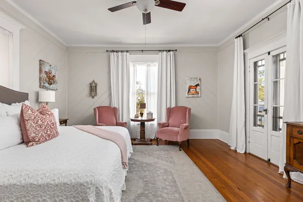 a bedroom with a bed couch and a window