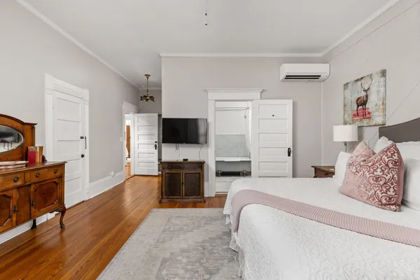 a bedroom with a bed and a flat screen tv