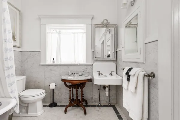 a bathroom with a toilet sink and mirror