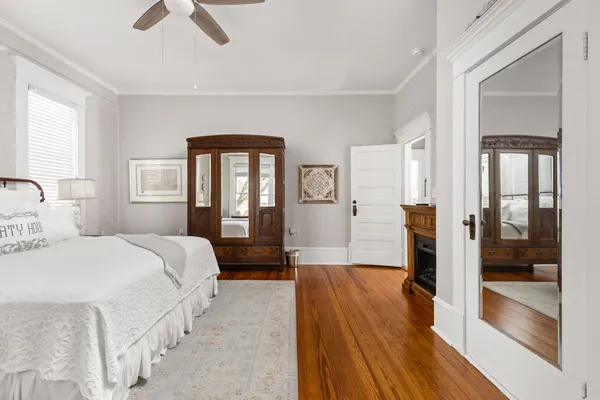 a bedroom with a bed and a chandelier