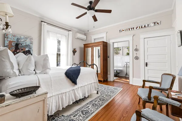 a bedroom with furniture and a rug