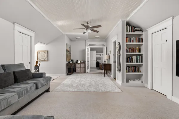 a living room with furniture and a book shelf