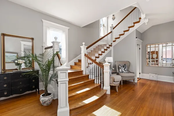 a view of entryway and hall with wooden floor