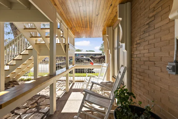 a view of a balcony with wooden floor
