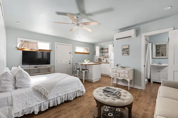 a bedroom with a bed a couch and dresser