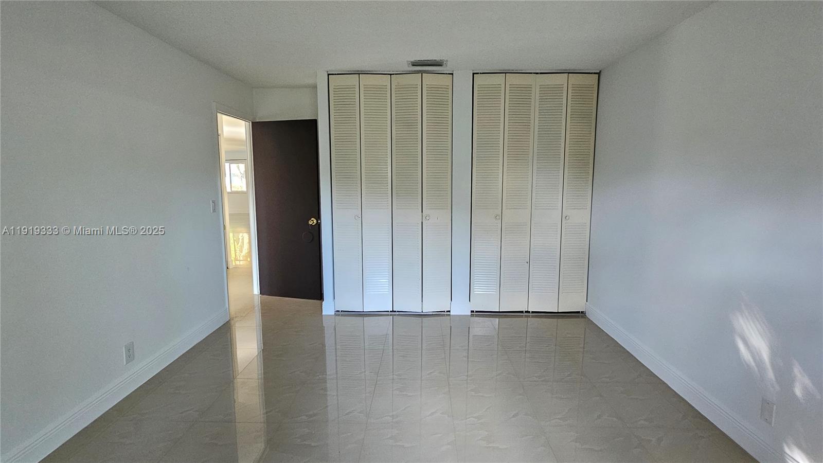 8004 Southwest 29th Street Davie, FL 33328 - Photo 11 of 39 an empty room with wooden floor and closet area