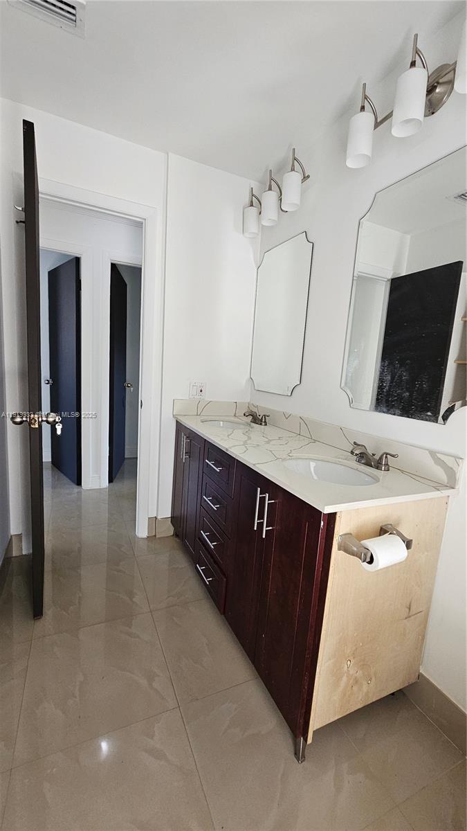 8004 Southwest 29th Street Davie, FL 33328 - Photo 17 of 39 a spacious bathroom with a double vanity sink and a mirror