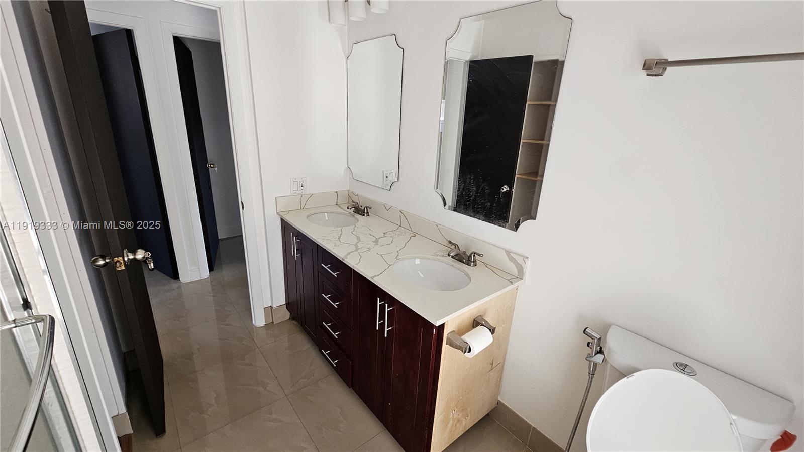 8004 Southwest 29th Street Davie, FL 33328 - Photo 18 of 39 a bathroom with a double vanity sink and mirror