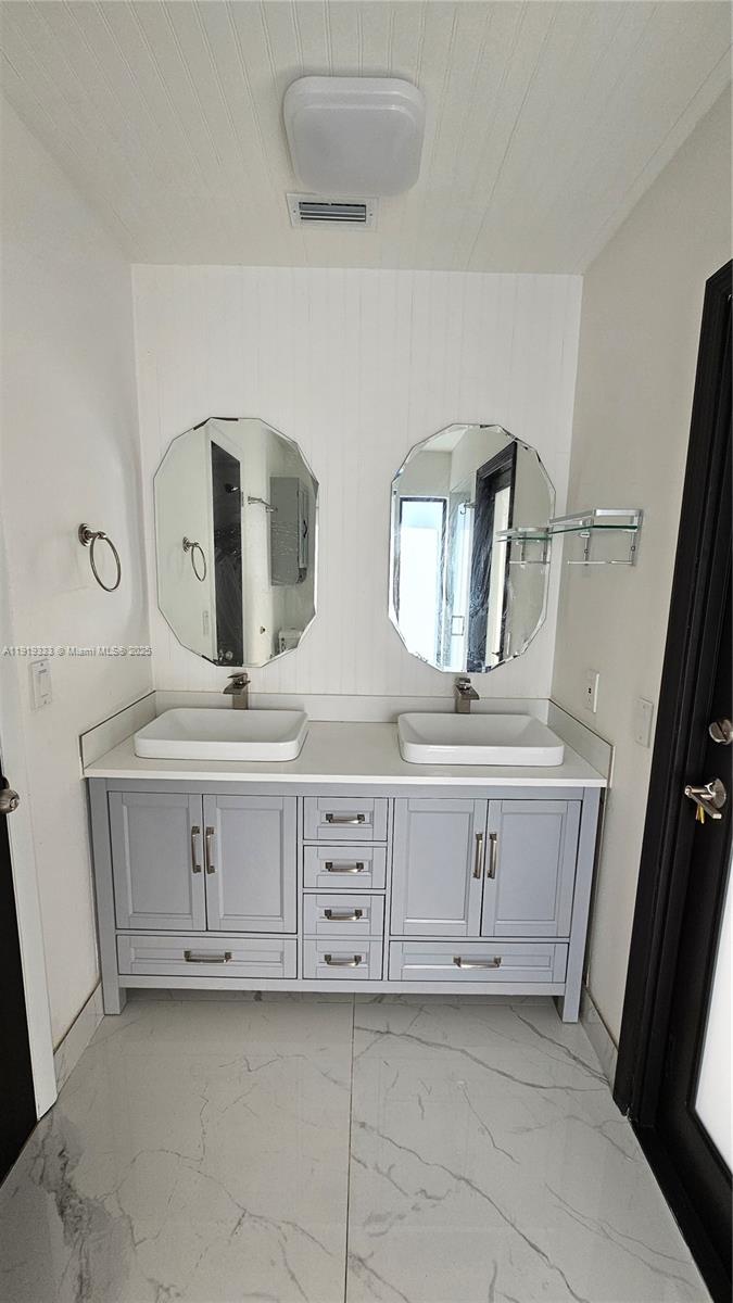 8004 Southwest 29th Street Davie, FL 33328 - Photo 21 of 39 a bathroom with double vanity sink and two mirror