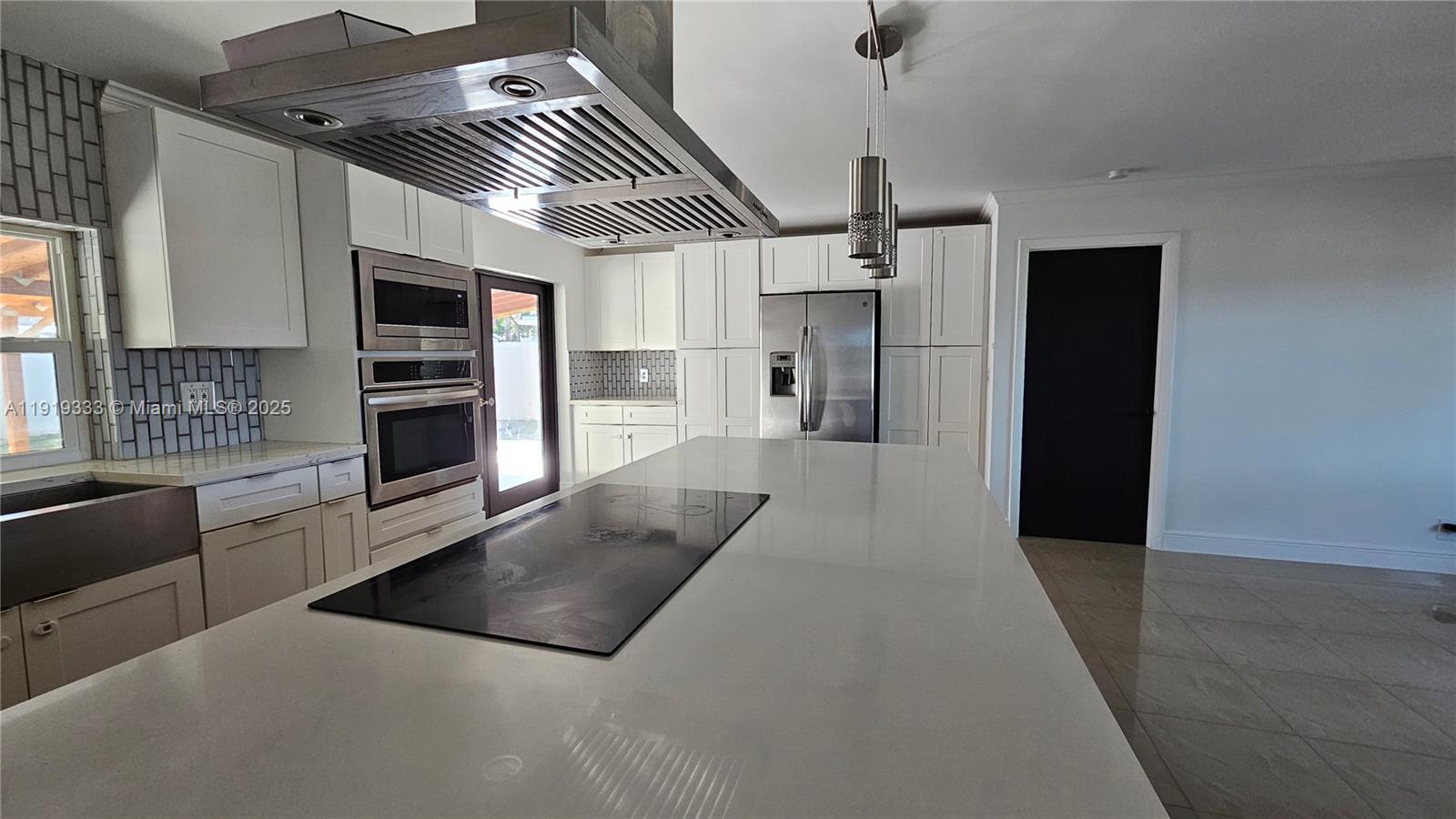 8004 Southwest 29th Street Davie, FL 33328 - Photo 33 of 39 a large kitchen with stainless steel appliances kitchen island granite countertop a refrigerator and a stove top oven