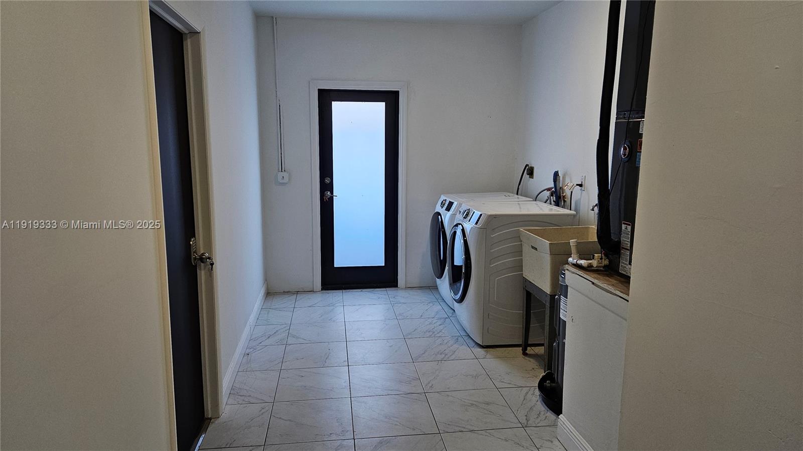 8004 Southwest 29th Street Davie, FL 33328 - Photo 36 of 39 a view of a storage and utility room with washer and dryer