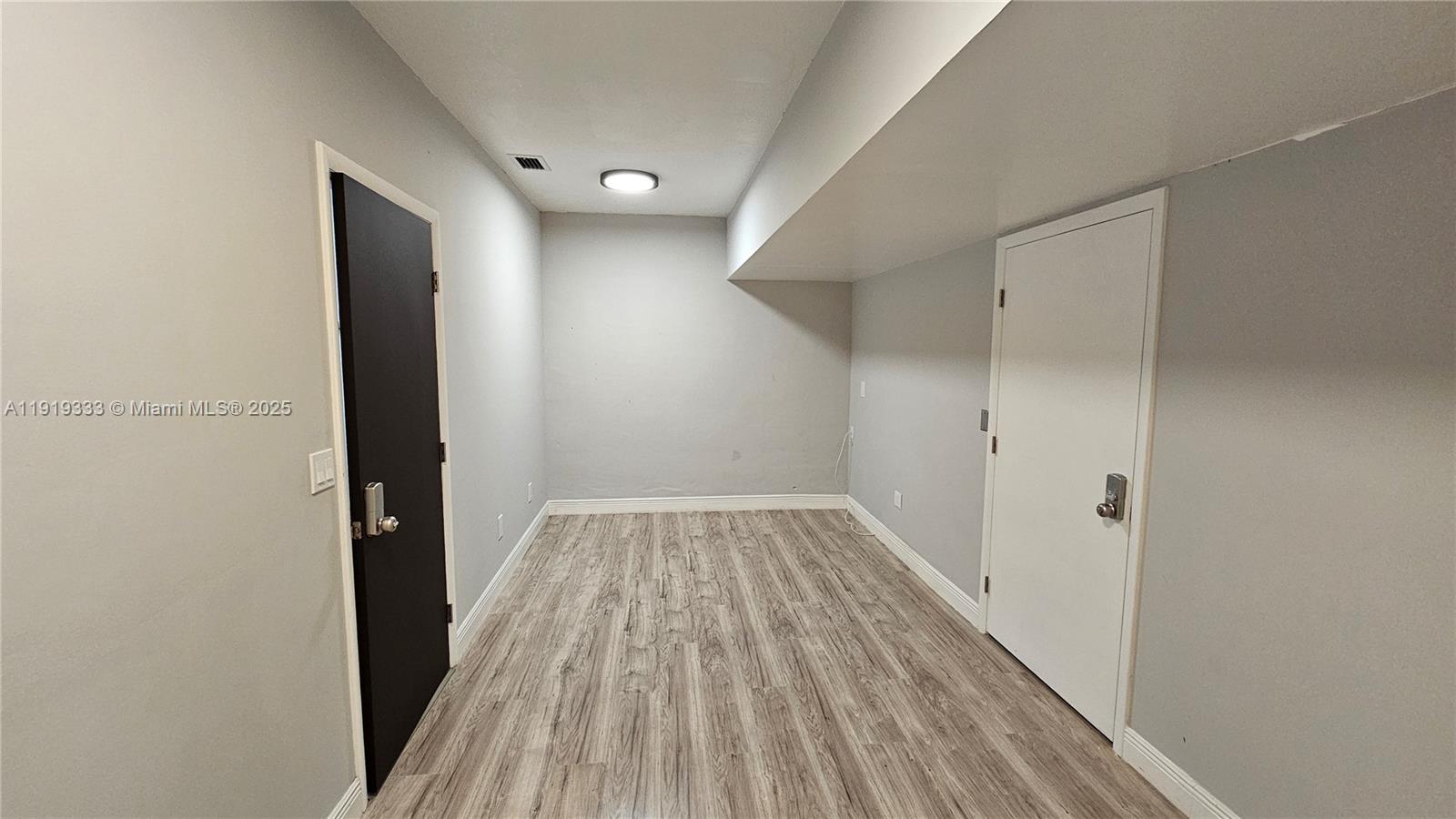 8004 Southwest 29th Street Davie, FL 33328 - Photo 37 of 39 a view of a hallway with wooden floor and a bathroom