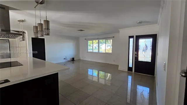 a open kitchen with refrigerator and window