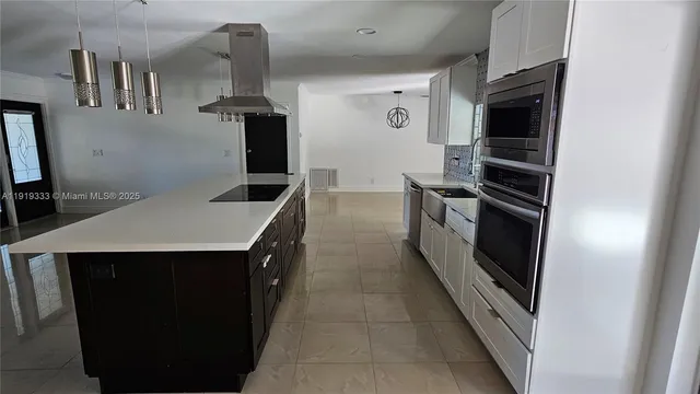 a kitchen with stainless steel appliances a stove and a refrigerator