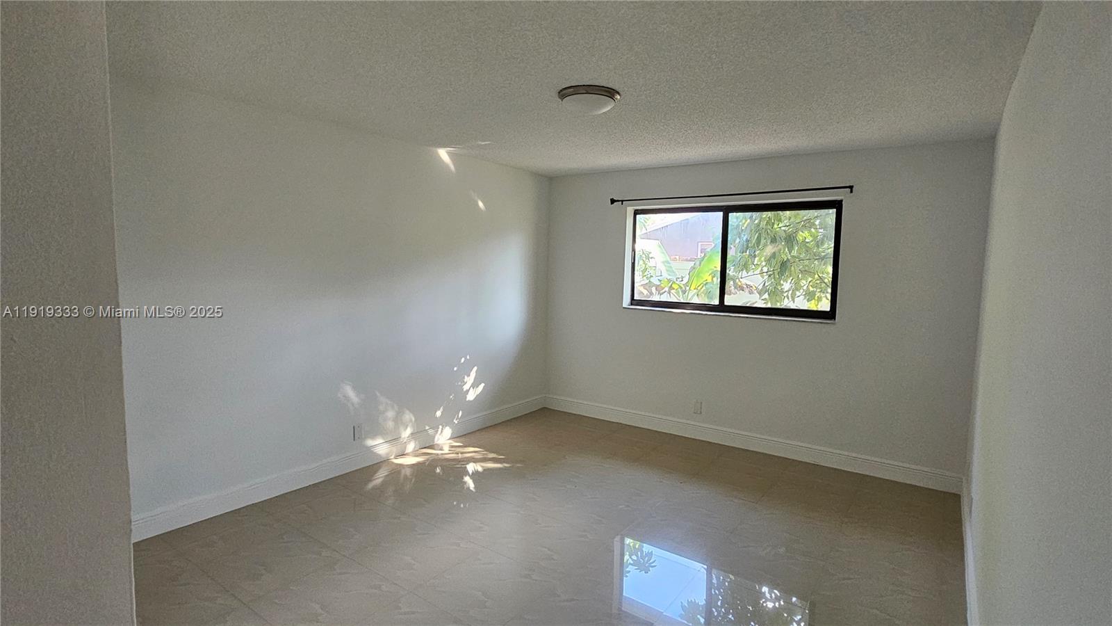 8004 Southwest 29th Street Davie, FL 33328 - Photo 10 of 39 an empty room with windows and fan