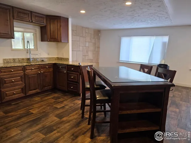 a kitchen with a stove a sink and cabinets