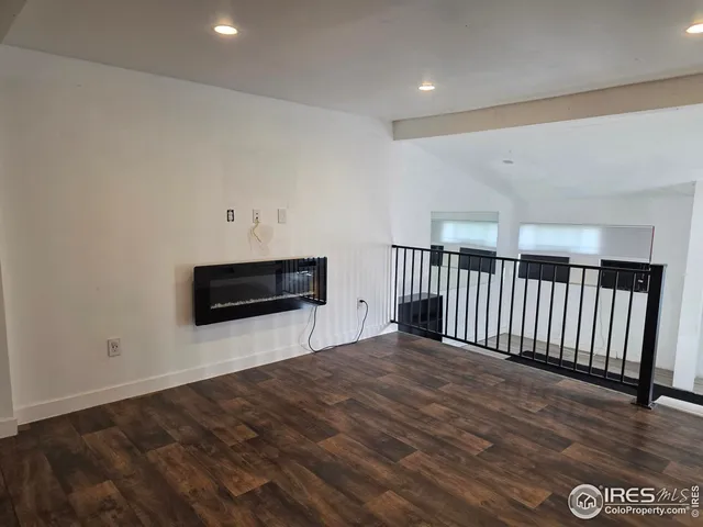 a view of a livingroom with an empty space and a window