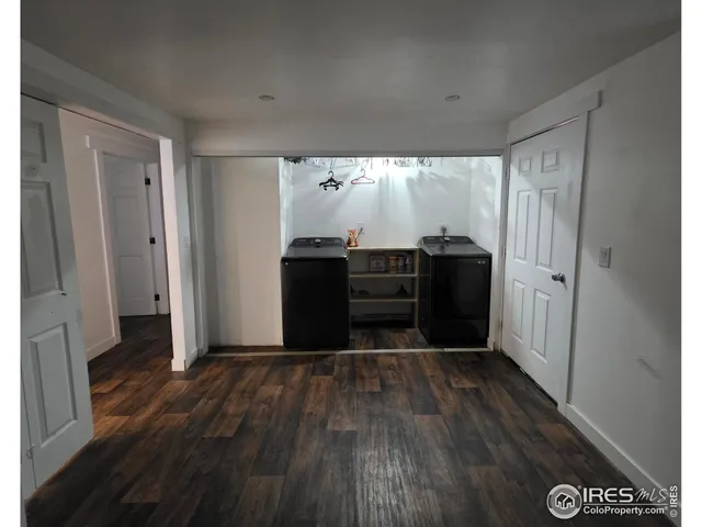 a view of a kitchen with wooden floor and electronic appliances